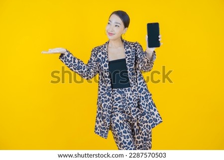 Portrait beautiful young asian woman smile with smart mobile phone on color background