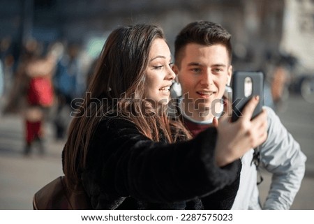 Couple of turists taking a selfie in an European city