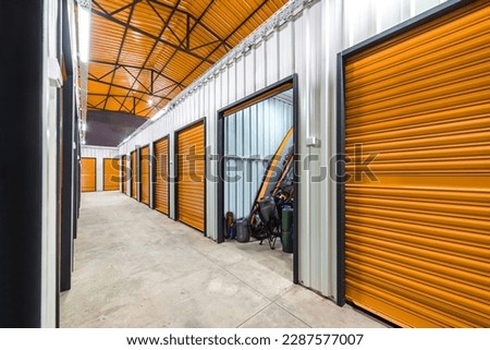 Corridor of self storage unit with red doors. Rental Storage Units Royalty-Free Stock Photo #2287577007