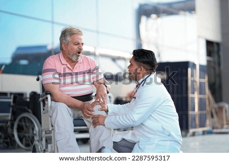 Doctor checking to old man while he is moaning in pain. Royalty-Free Stock Photo #2287595317