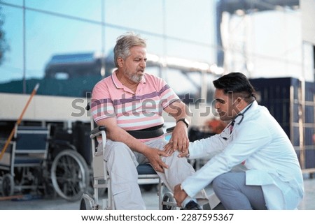 Doctor checking to old man while he is moaning in pain. Royalty-Free Stock Photo #2287595367