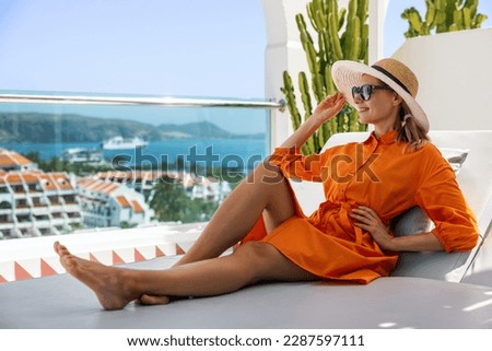 woman relaxing in sunbed at penthouse apartment and enjoying summer vacations in Tenerife Royalty-Free Stock Photo #2287597111