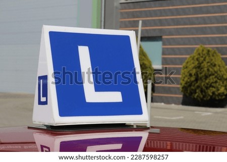 Driving school car. L sign. Driving lessons car. Learning how to drive a car.