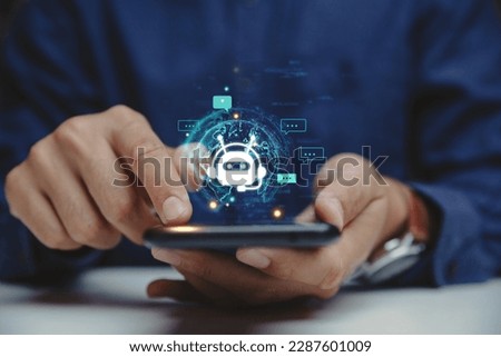 Hand of businessman using smartphone chatting with chat bot, Chat with AI or Artificial Intelligence technology. Royalty-Free Stock Photo #2287601009