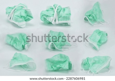 Crumpled used disposable face mask isolated over white background