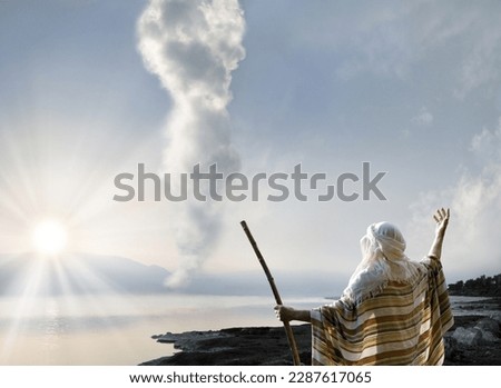 Retro holy Jesus Christ adult age wise saint male human rise arm hold wood wand rod cane back view. Middle east jew cloth Lord law torah exodus story magic egypt cloudy smoke sun light symbol concept Royalty-Free Stock Photo #2287617065