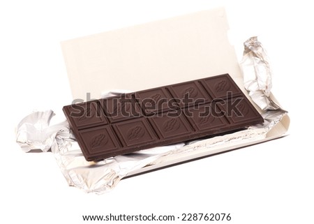 Milk chocolate with foil and wrapper isolated on white background