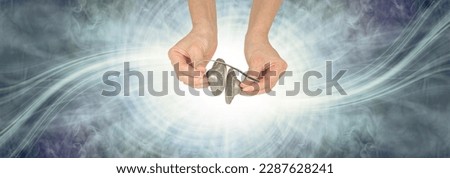 Sound Healer and Vortexing  Healing Energy Waves - Female hands holding ting sha percussion bells against white spiraling light and blue green wispy energy field with copy space all around
 Royalty-Free Stock Photo #2287628241