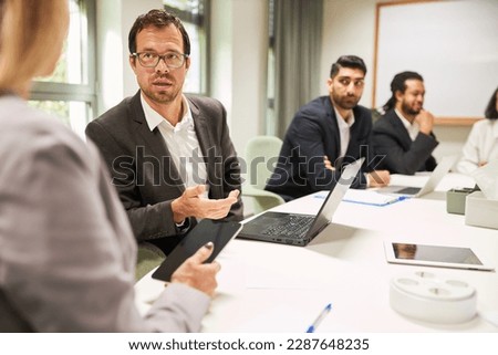 Business man as a consultant in a meeting in the consulting workshop in the office at the conference table Royalty-Free Stock Photo #2287648235