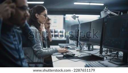 Portrait of a Thoughtful Female Engineer Working on Computer in a Technological Office Environment. Research and Development Department Writing Software Code for an Innovative Internet Project Royalty-Free Stock Photo #2287651179