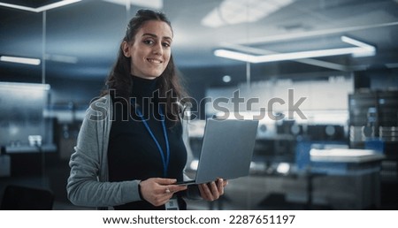 Portrait of a Young Attractive Empowered Multiethnic Woman Looking at Camera and Charmingly Smiling. Specialist at Work, Information Technology Manager, Software Engineering Professional Royalty-Free Stock Photo #2287651197