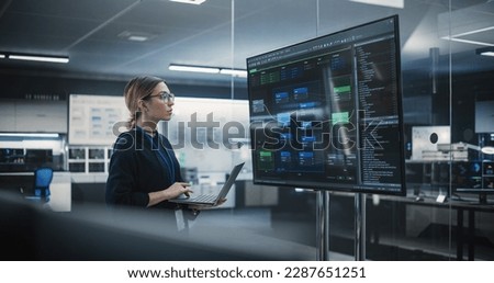 Portrait of a Multiethnic QA Engineer Working on Finding and Fixing Bugs in a Product or Program Software Code Before the Launch. Female Using Laptop Computer, Collaborating with Developers Online Royalty-Free Stock Photo #2287651251