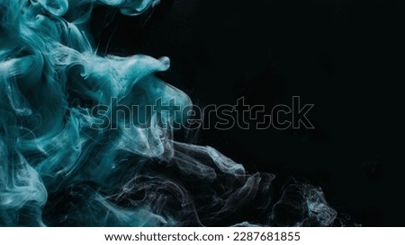 Ink water. Mist floating. Acrylic paint splash. Blue color glowing glitter fog wave on black abstract art background with copy space.