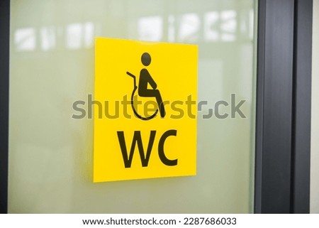 Yellow toilet sign for people with disabilities