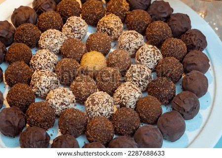 Closeup of some of the different types of exquisite chocolates for sale in shops specializing in the famous Belgian chocolate in Belgium.