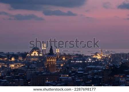 Galata tower in Istanbul, Turkey. Aerial view of landmark at golden hour with beautiful sunlight. Snow and winter season view in Istanbul Suleymaniye Mosque and Galata tower.