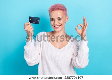 Photo of funny gorgeous glamour lady wear trendy clothes demonstrate debit card okey symbol isolated on blue color background