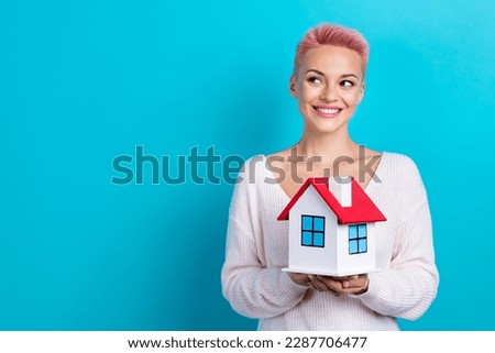 Photo of new real estate agent property owner hold paper house looking empty space promotion cheap price insurance isolated on cyan color background