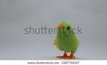 walking green chicken toy for kids. little baby chicken toy isolated on white background.
