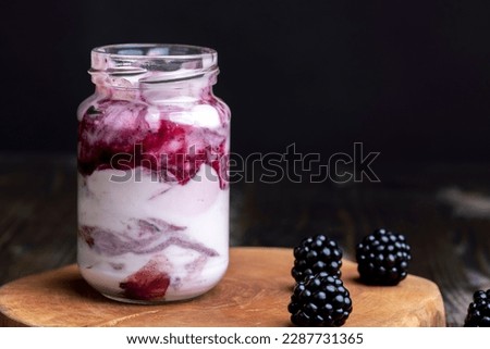 Fresh delicious milk yogurt with blackberry flavor, yogurt with fresh berries and blackberry jam