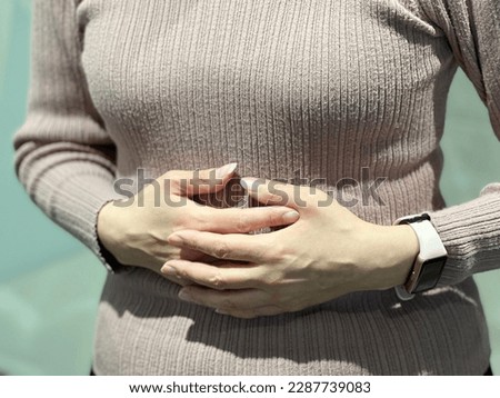 woman holding her chest with both hands Royalty-Free Stock Photo #2287739083