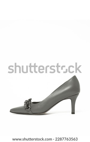 Grey leather pumps with rhinestones isolated on white. Classic middle heels with sharply pointed toes.
