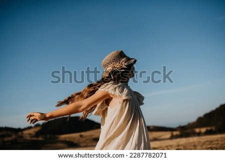 Portrait of a beautiful little girl feeling free in summer in nature. Royalty-Free Stock Photo #2287782071