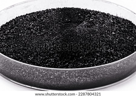 petri dish with black powder, powdered charcoal used in the pharmaceutical or beauty industry, MACRO PHOTOGRAPHY