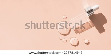 pipette drop of serum test on a beige background sun glare Royalty-Free Stock Photo #2287814949