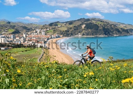 nice senior woman cycling with her electric mountain bike in the hills above Zarautz, Basque region, Spain Royalty-Free Stock Photo #2287840277