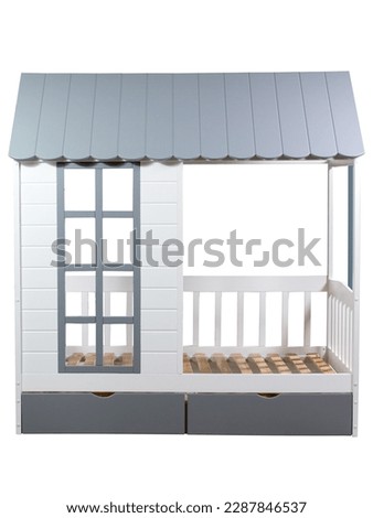 Baby crib in the form of a wooden house on a white background