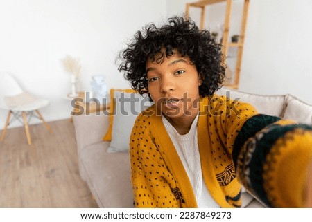 Happy african american teen girl blogger smiling face talking to webcam recording vlog. Social media influencer woman streaming making video call at home. Headshot portrait selfie webcamera view Royalty-Free Stock Photo #2287849273