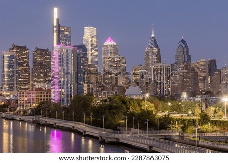Philadelphia Downtown skyline at Night with the Schuylkill river. Beautiful Sunset Light. Schuylkill River Trail in Background. City skyline glows under the beautiful sunset light. PA, USA.