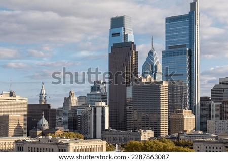 Philadelphia City Center and Business District Skyscrapers. Cloudy Blue Sky, Beautiful Sunlight. City Hall Statue in Background