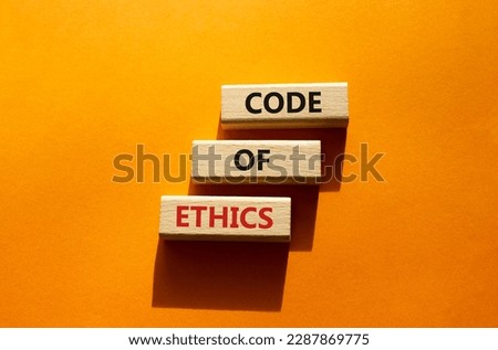 Code of ethics symbol. Concept words Code of ethics on wooden blocks. Beautiful orange background. Business and Code of ethics concept. Copy space.