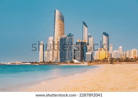 Panoramic view of stunning sandy beach near Corniche seaside embankment with great sunset view of Abu Dhabi, UAE towering skyscrapers Royalty-Free Stock Photo #2287892041