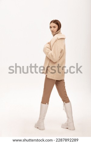 A beautiful business woman in a fur coat on a light background, a photo for a marketplace, a product demonstration, artificial fur, a girl posing in a fur coat made of artificial fur
