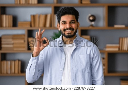 Positive attractive Arab young man showing ring gesture with fingers.close up portrait, good job, agreement concept. I am OK, approval.