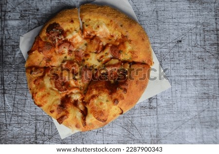 pizza arranged in such a way with a textured background. Personal pizza with a variety of toppings looks delicious