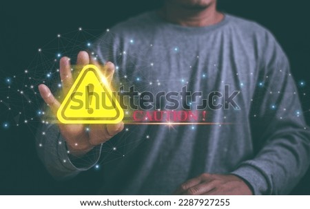 Businessman raising his hand in front indicating order to stop, Yellow triangle caution warning sign for maintenance notification error and risk concept.