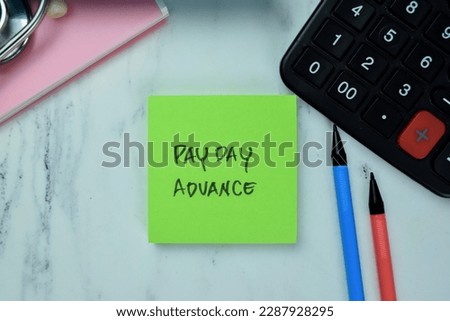 Concept of Pay Day Advance write on sticky notes isolated on Wooden Table.
