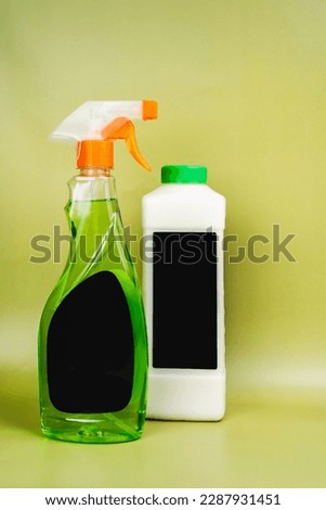 Eco-friendly glass cleaner.  Cleans car, glass, mirrors without streking. Safely cleans dirt, dust and greasy fingerprints. Spray bottle on a light blue background.  Place for text. Mockup