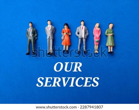Miniature people with the word OUR SERVICES on a blue background. Business concept.