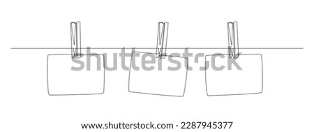 Photo frames hanging on the rope with clothespins in one continuous line drawing. Clothesline with pin and peg for photo album design concept in simple linear style. Editable stroke. Vector