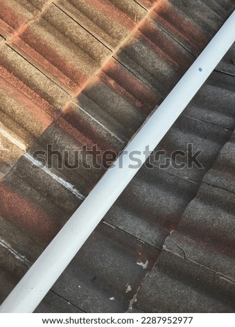 PVC pipe lay cross tile roof for channelling out water. 
