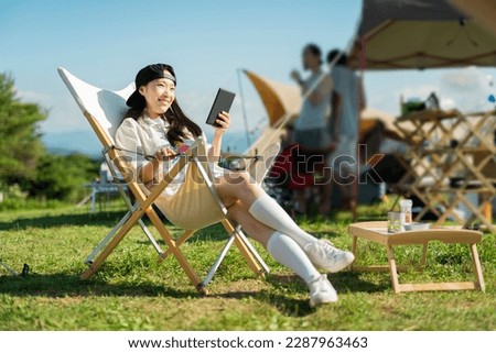 Woman watching video at campsite
