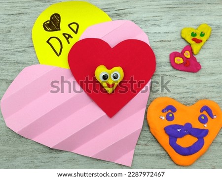 Fathers day, Birthday or Valentines day . Child making funny crafts, greeting card from paper and clay, plasticine.  Arts  crafts concept.