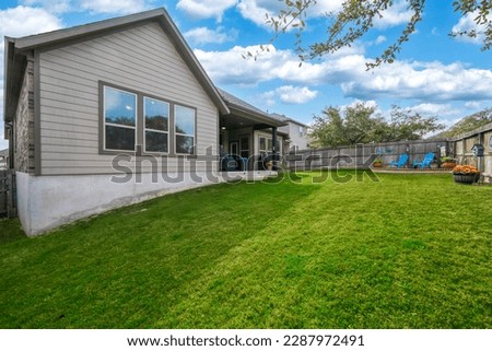 A back yard with a green lawn  Royalty-Free Stock Photo #2287972491