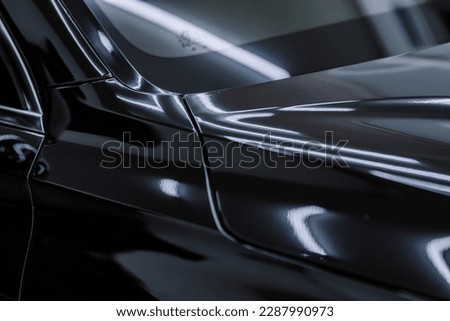 shiny paint on black cars. Glossy paint on a black car. Royalty-Free Stock Photo #2287990973