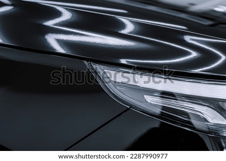 shiny paint on black cars. Glossy paint on a black car. Royalty-Free Stock Photo #2287990977